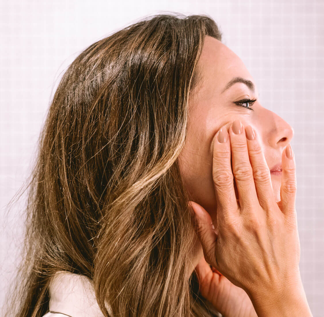 Frau die Revitalisierende Anti-Aging Creme aufträgt